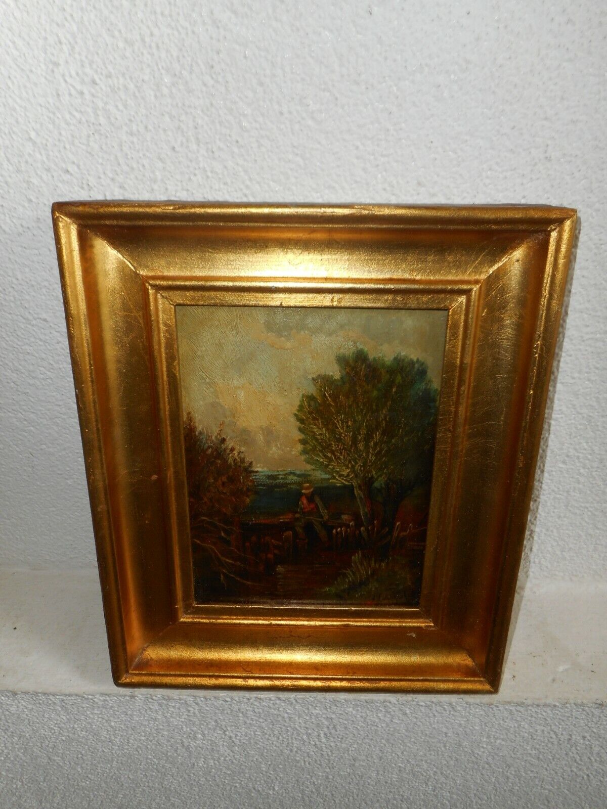 Antique oil painting +- 1880,{ Woodslandscape with a man fishing, is signed }.