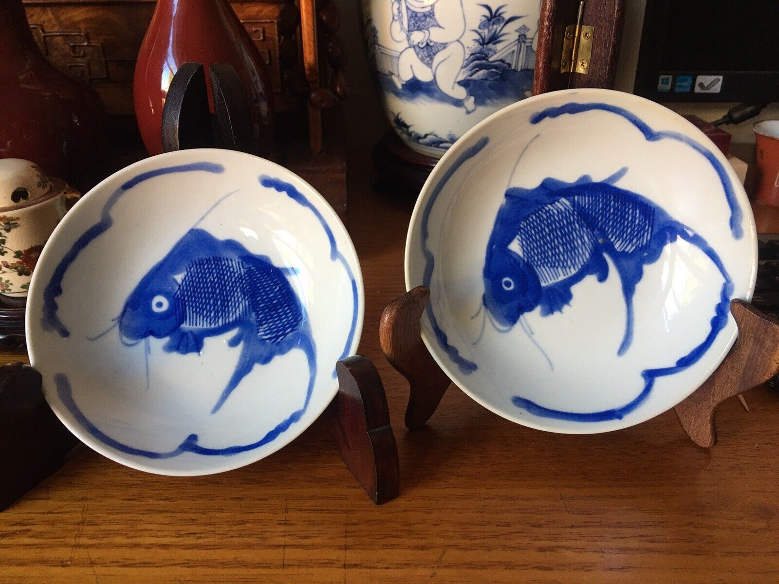 A pair of Chinese antique blue and white fish plates