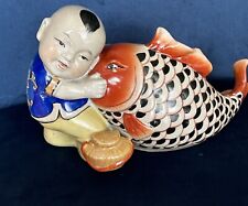 Chinese Porcelain Figurine of a Boy Hugging a Giant Koi Carp Fish Vintage picture