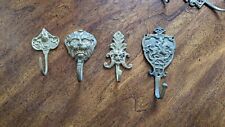 Four Mixed Antique Brass Coat Hooks picture